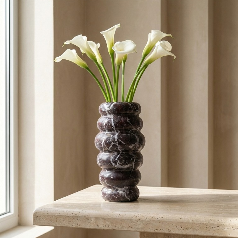 Handcrafted Rosso Levanto marble vase used as flower vase in luxury space
