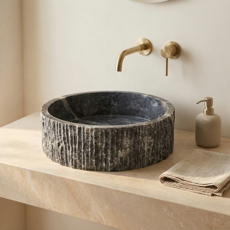 Luxury bathroom interior featuring dark grey marble round vessel sink