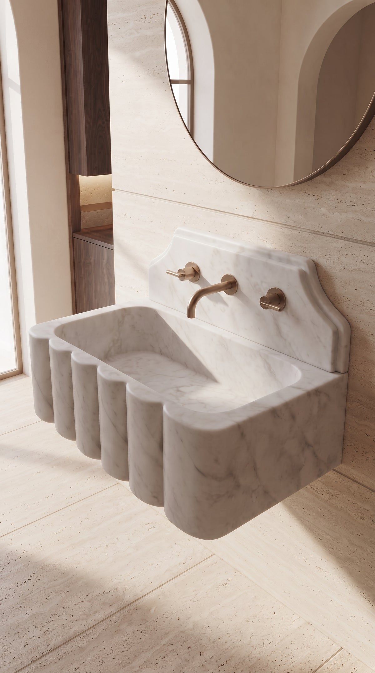 Sculptural Muğla White marble bathroom sink in a Mediterranean inspired interior with light natural stone walls and soft daylight.