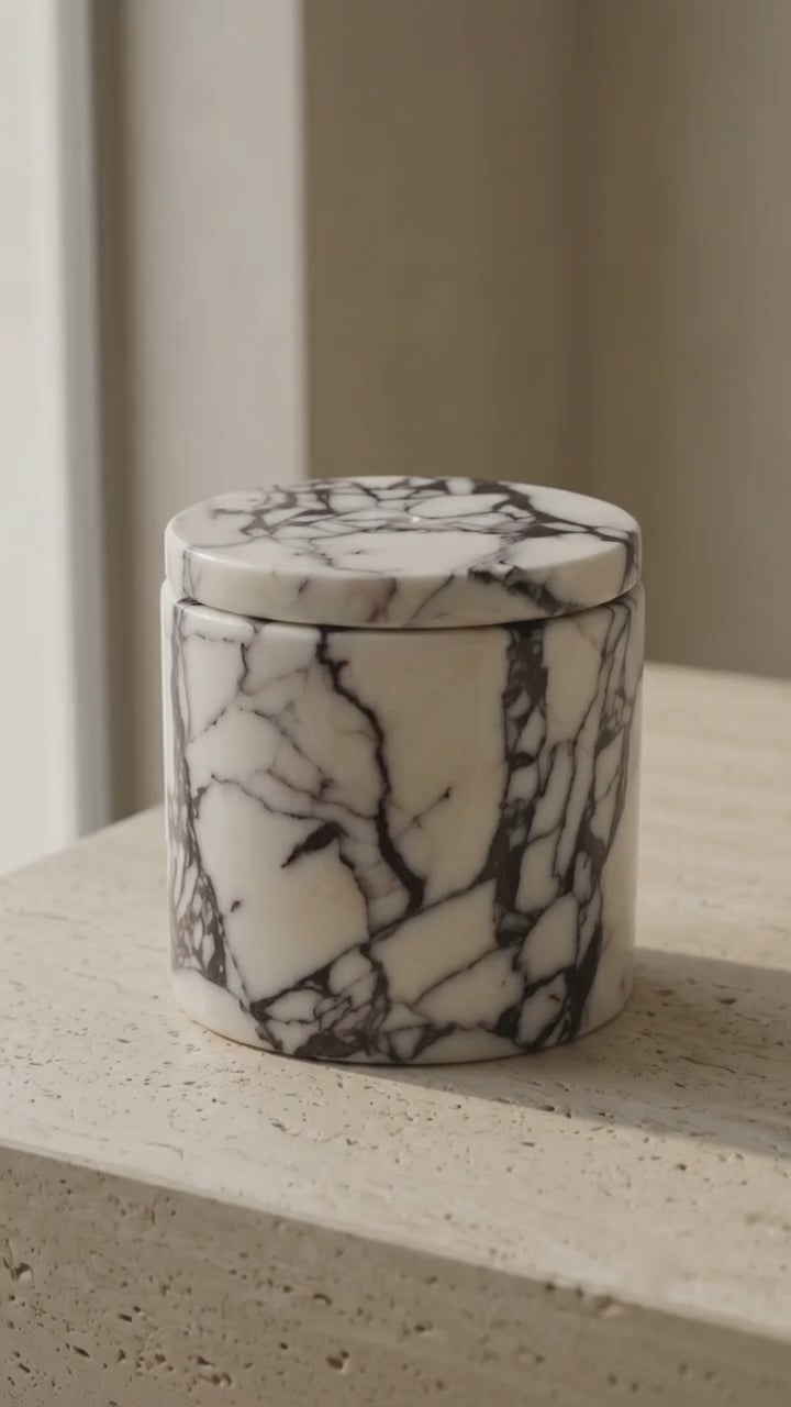 Video showing reusable Calacatta Viola marble candle holder with luxury 3 wick candle.
