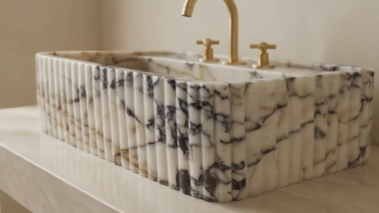 Video showcasing handcrafted Calacatta Viola marble sink details, texture, and luxury finish