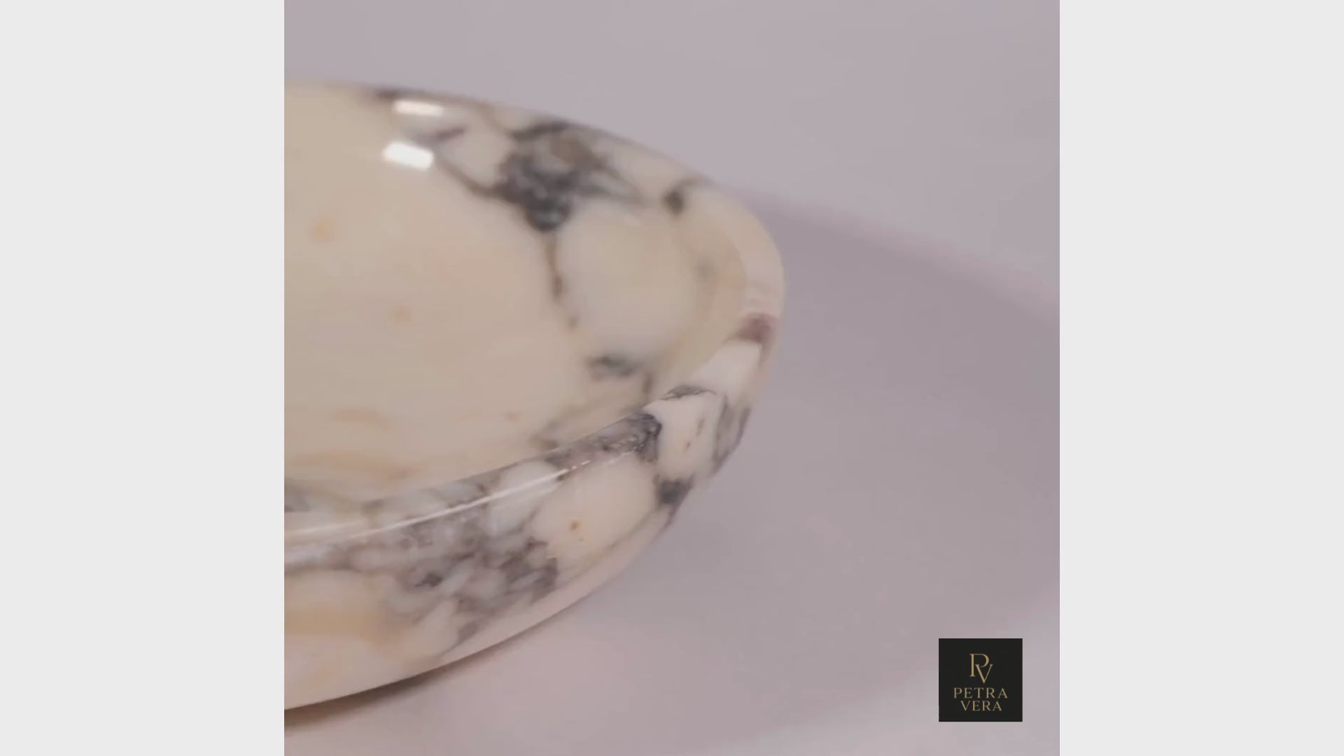 Short cinematic video showing Calacatta Viola marble bowl’s texture, craftsmanship and reflective surface in soft light.