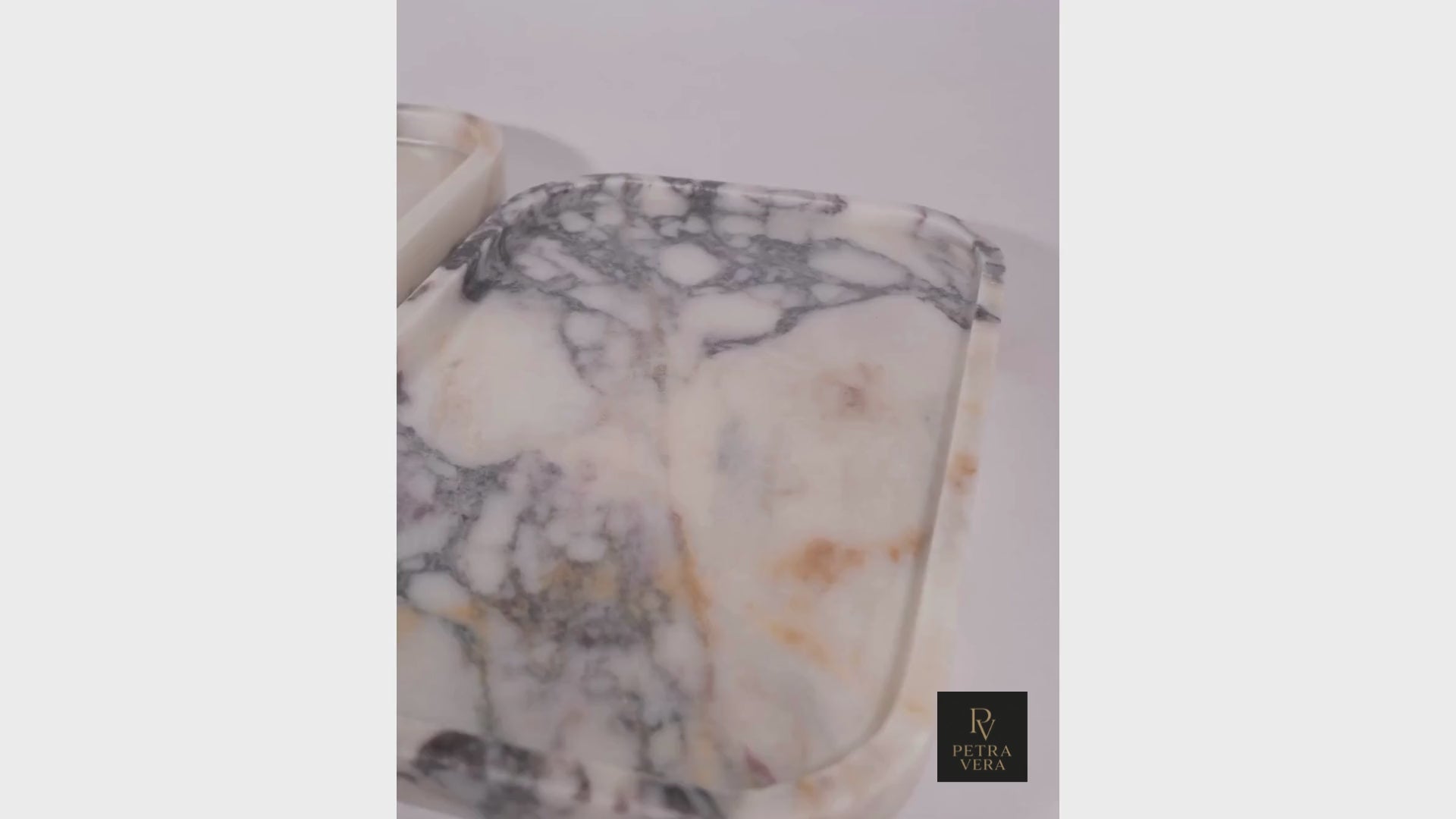 Short video showing Calacatta Viola marble tray surface details and natural light reflections.