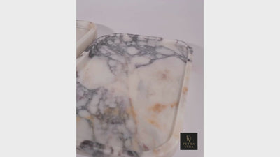 Short video showing Calacatta Viola marble tray surface details and natural light reflections.