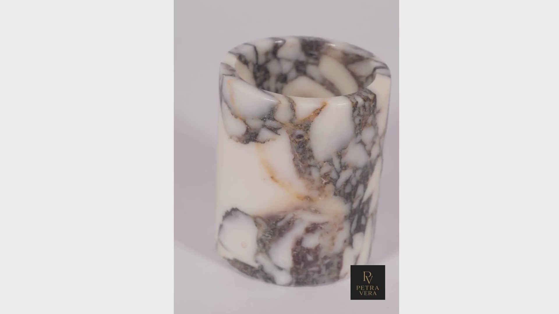 360° view of handcrafted Calacatta Viola marble pen holder – polished surface reflecting natural light, luxury desk accessory.