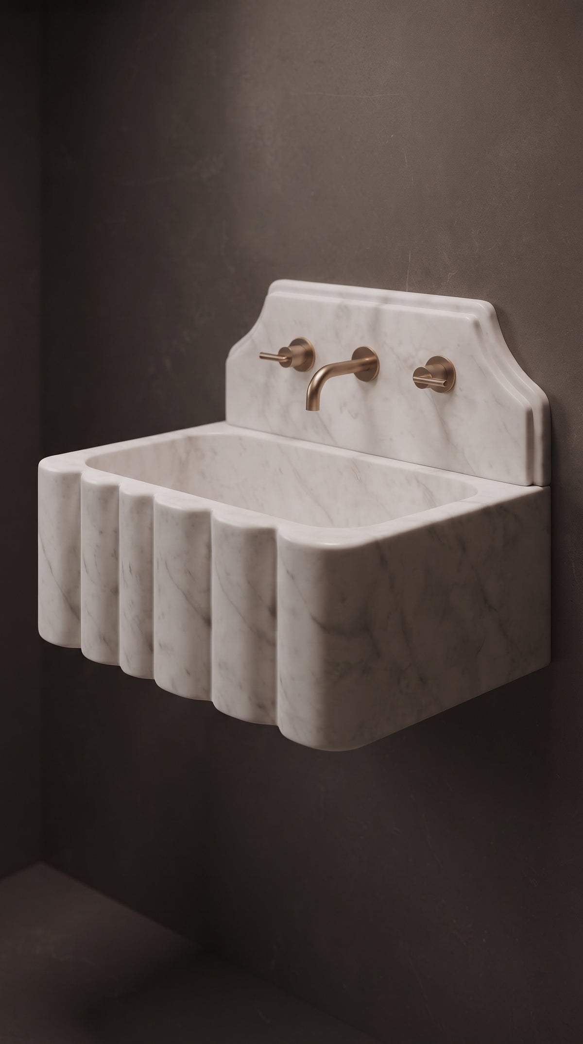 Three quarter view of a handcrafted Muğla White marble wall mounted sink highlighting the rounded fluted front and solid stone side.