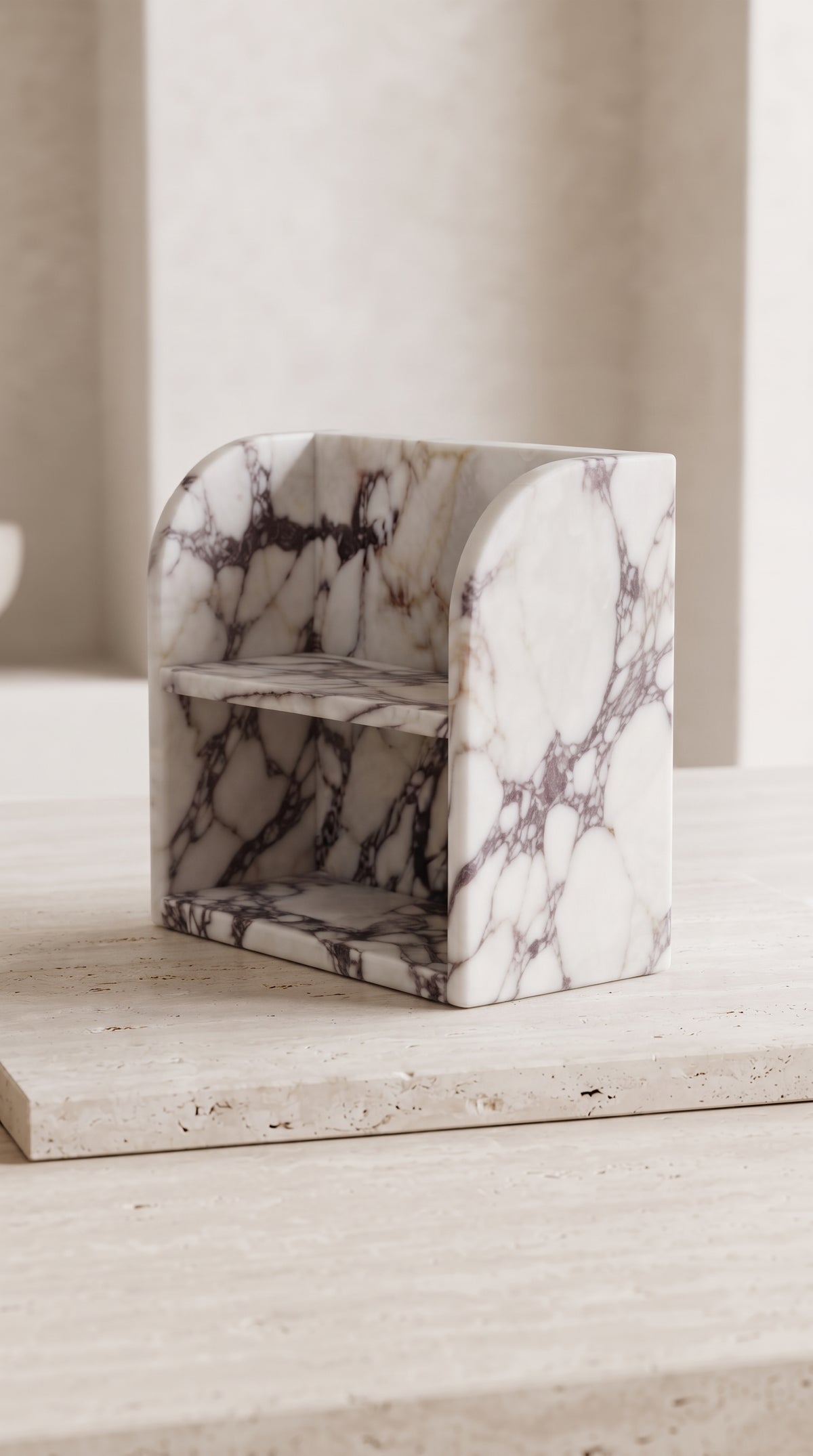 Sculptural side profile of Calacatta Viola marble organizer with rounded edges and two-tier design
