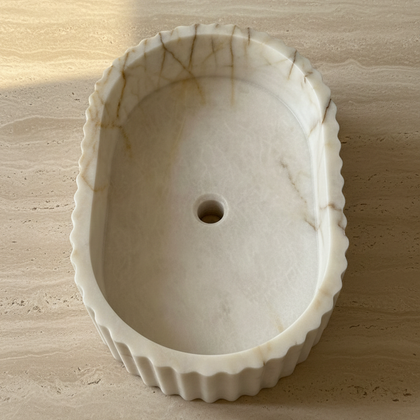 Top view of fluted marble vessel sink showing round basin shape and hand-carved stone texture in Afyon Seker marble