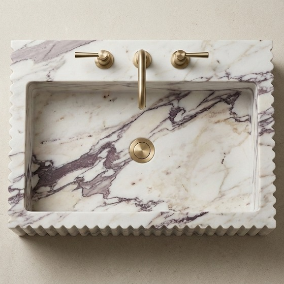 Top view of fluted Calacatta Viola marble sink showing basin depth and natural stone patterns