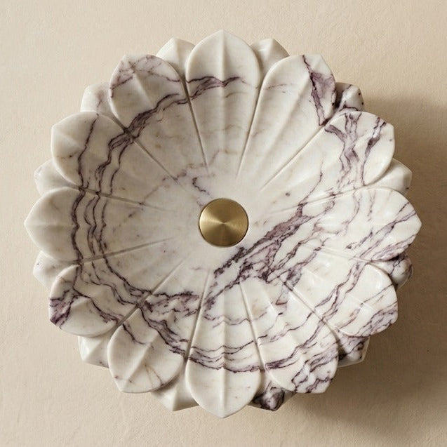 Top view of marble flower vessel sink showing petal shaped design and natural stone veining
