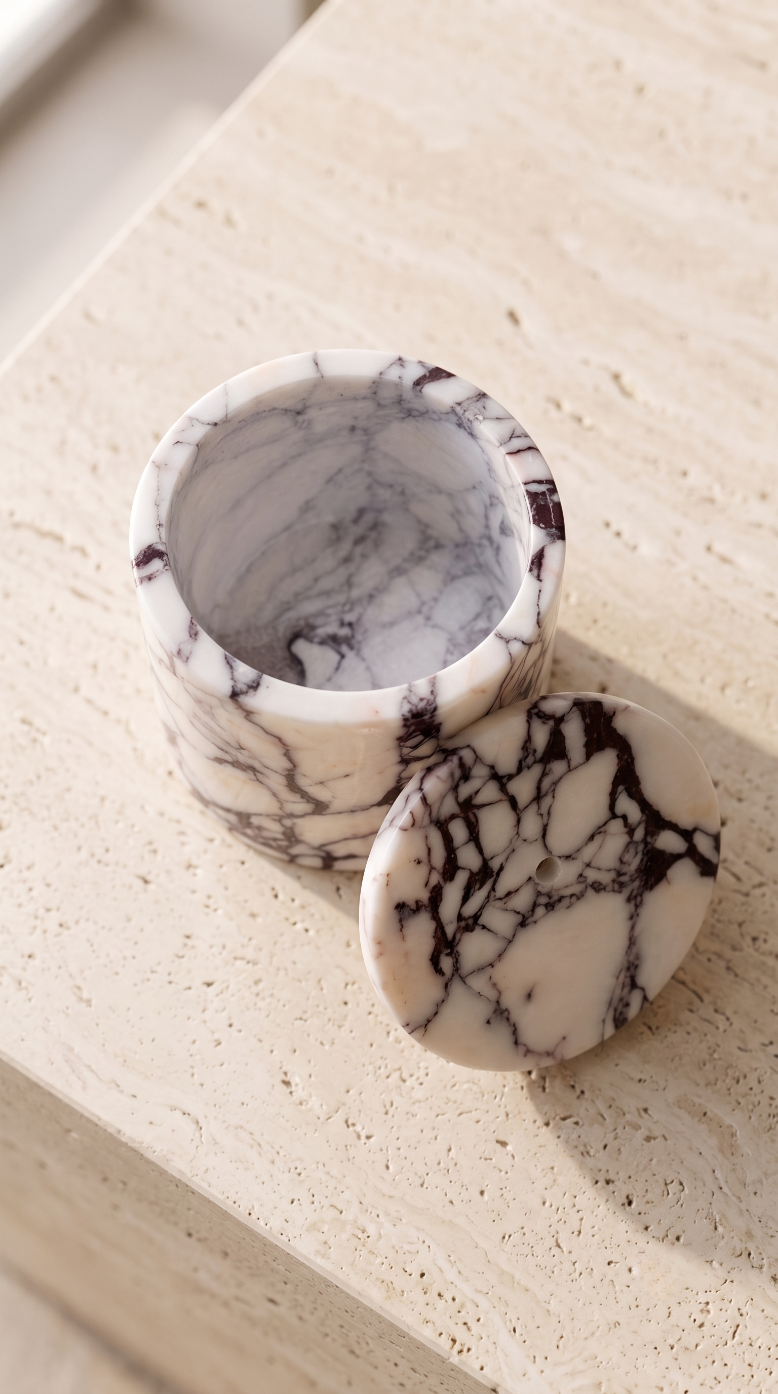 Top view of handcrafted Calacatta Viola marble candle holder showing natural veining.
